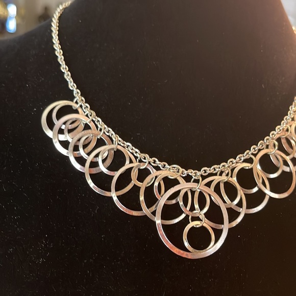 Light silver toned necklace with a variety of circles suspended on silver chain - Picture 6 of 13